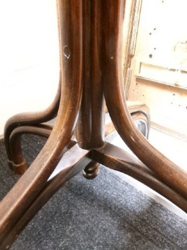 A dark brown bentwood hat and coat stand featuring multiple curved upper hooks, a circular ring, and a four-legged splayed base. View III