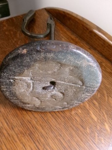 An 18th-century hand-forged wrought iron rushlight holder with an integrated candle socket, mounted on a turned dome fruitwood base. View V