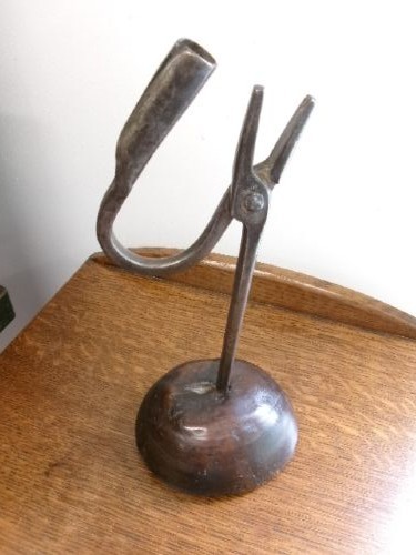 An 18th-century hand-forged wrought iron rushlight holder with an integrated candle socket, mounted on a turned dome fruitwood base. View VII