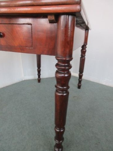 A Victorian mahogany draw leaf dining table with turned legs and a single frieze drawer with a wooden knob. View II