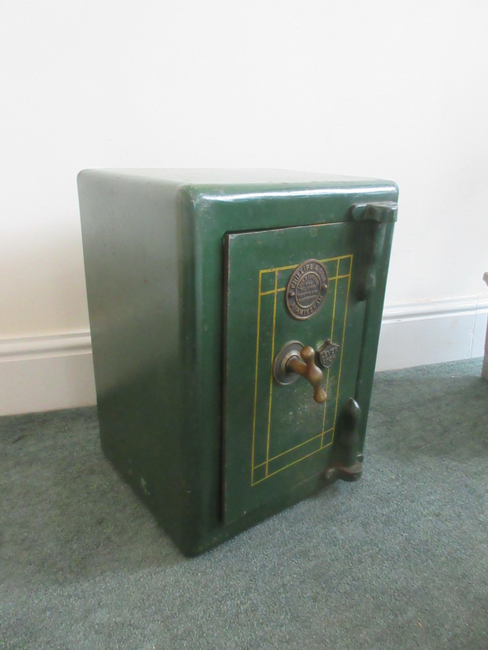 A Victorian mahogany cabinet with a white marble top, featuring an open door revealing an enclosed green cast iron safe inside. View II
