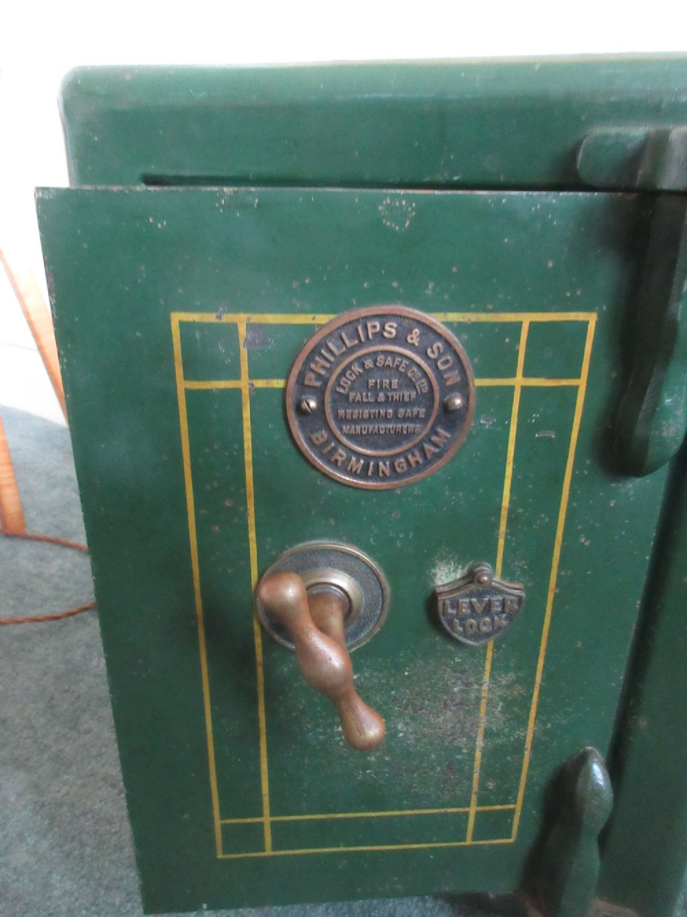 A Victorian mahogany cabinet with a white marble top, featuring an open door revealing an enclosed green cast iron safe inside. View IV