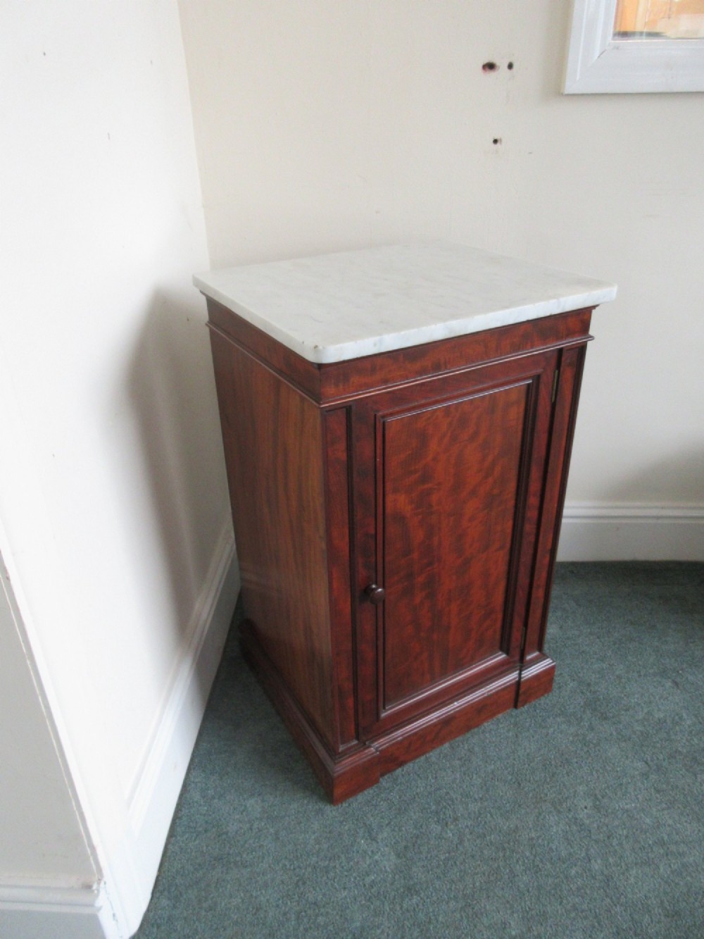 A Victorian mahogany cabinet with a white marble top, featuring an open door revealing an enclosed green cast iron safe inside. View V
