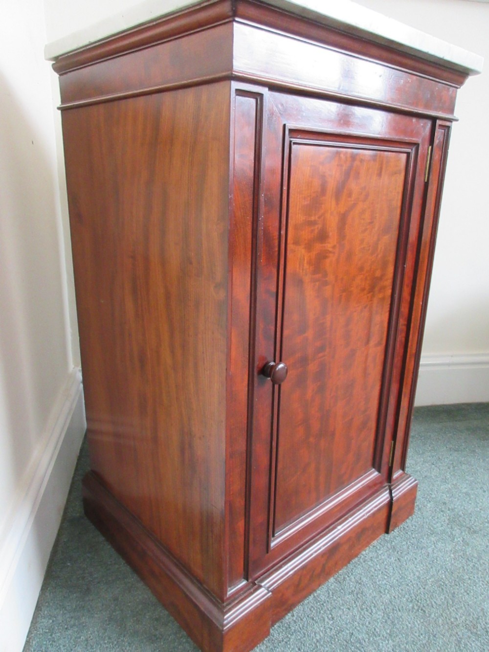 A Victorian mahogany cabinet with a white marble top, featuring an open door revealing an enclosed green cast iron safe inside. View VI