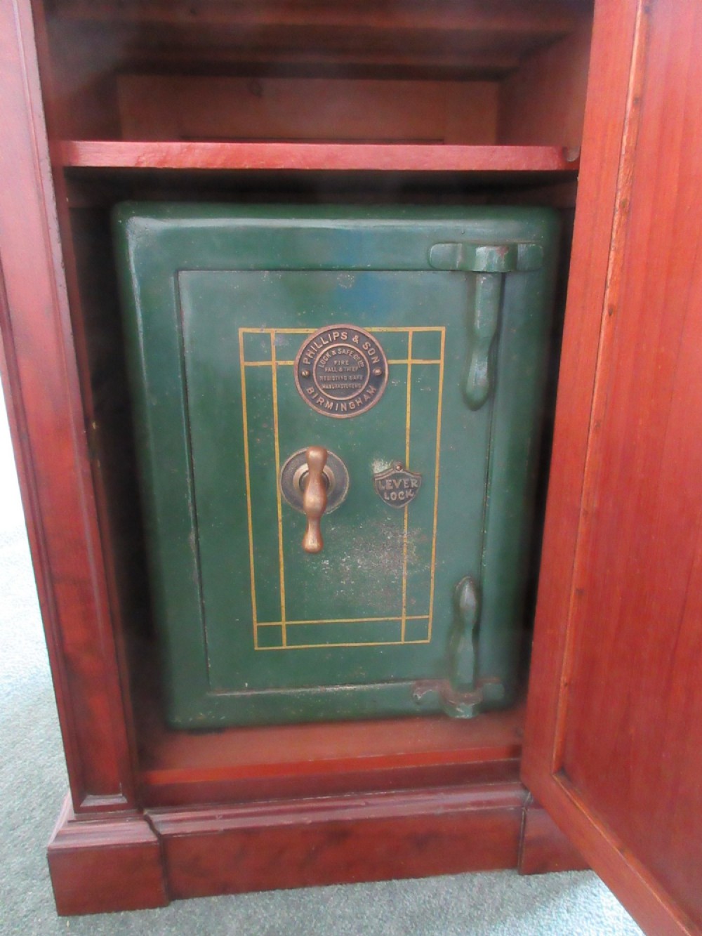 A Victorian mahogany cabinet with a white marble top, featuring an open door revealing an enclosed green cast iron safe inside. View VIII