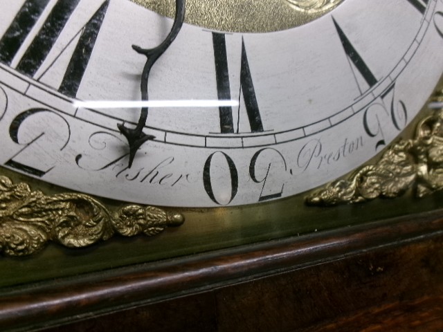 An 18th-century Georgian dark oak longcase clock featuring a square brass dial, fluted hood columns, and a moulded base. View IV