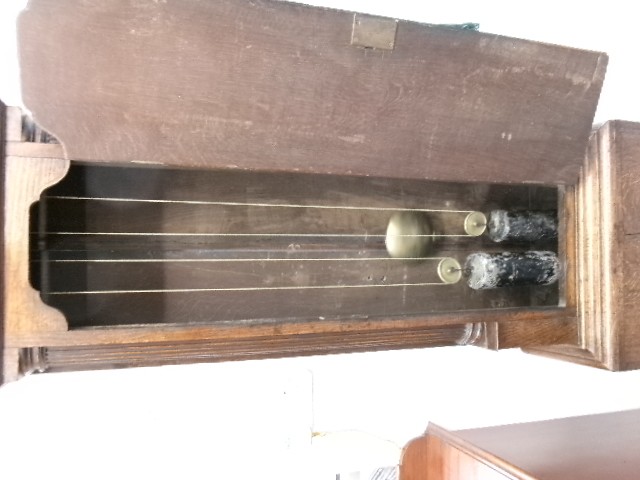 An 18th-century Georgian dark oak longcase clock featuring a square brass dial, fluted hood columns, and a moulded base. View IX