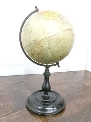 A small 1930s Philips terrestrial globe with printed paper map gores mounted on a dark turned metal and wooden stand. View III