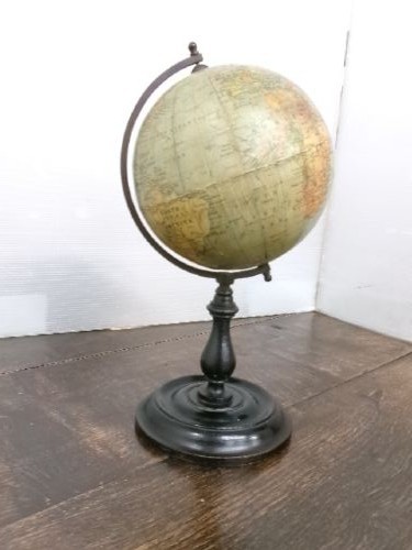 A small 1930s Philips terrestrial globe with printed paper map gores mounted on a dark turned metal and wooden stand. View X