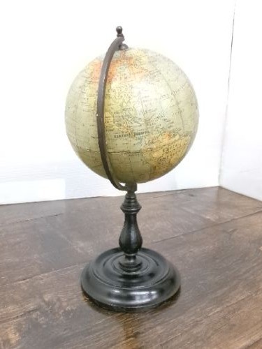 A small 1930s Philips terrestrial globe with printed paper map gores mounted on a dark turned metal and wooden stand. View IX