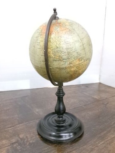 A small 1930s Philips terrestrial globe with printed paper map gores mounted on a dark turned metal and wooden stand. View VIII