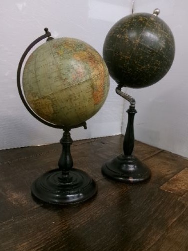 A small 1930s Philips terrestrial globe with printed paper map gores mounted on a dark turned metal and wooden stand. View XI