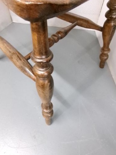 A Victorian wooden kitchen chair featuring a shaped elm seat, turned spindles, curved top crest rail, and turned legs with stretchers. View II