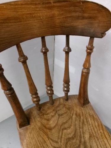 A Victorian wooden kitchen chair featuring a shaped elm seat, turned spindles, curved top crest rail, and turned legs with stretchers. View III