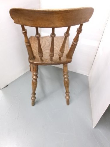 A Victorian wooden kitchen chair featuring a shaped elm seat, turned spindles, curved top crest rail, and turned legs with stretchers. View IV