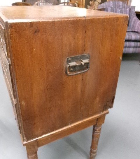 A pine military campaign chest featuring flush recessed brass handles and multiple small drawers. View X