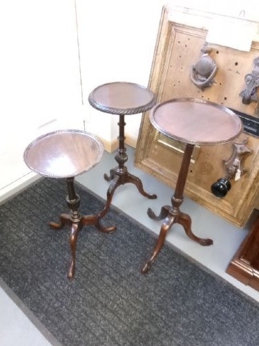 A trio of Edwardian mahogany wine tables featuring turned central pedestals, dished circular tops, and carved tripod cabriole legs. View II