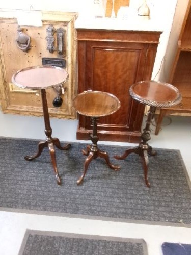 A trio of Edwardian mahogany wine tables featuring turned central pedestals, dished circular tops, and carved tripod cabriole legs. View X