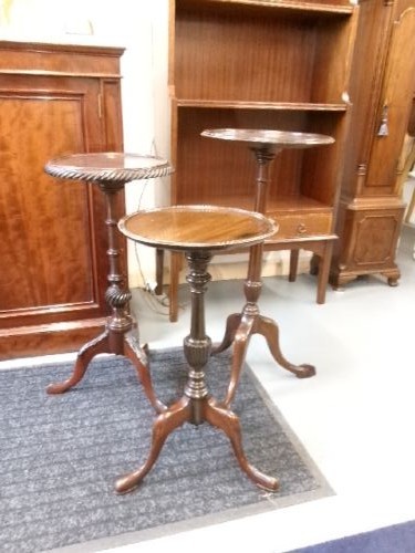 A trio of Edwardian mahogany wine tables featuring turned central pedestals, dished circular tops, and carved tripod cabriole legs. View XIV