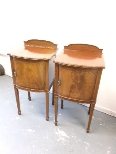 A pair of Edwardian mahogany bedside cabinets featuring bow fronts, satinwood string inlay, shaped upstands, and tapered legs. View VIII
