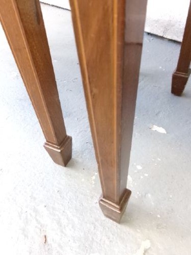 A pair of Edwardian mahogany bedside cabinets featuring bow fronts, satinwood string inlay, shaped upstands, and tapered legs. View XI