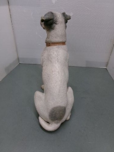 A Victorian painted terracotta figure depicting a seated Jack Russell terrier with grey ears and a brown painted collar. View VI