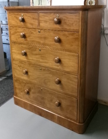 A tall Victorian mahogany chest of drawers featuring two short upper drawers above four long drawers with turned wooden knobs and a solid plinth base. View X