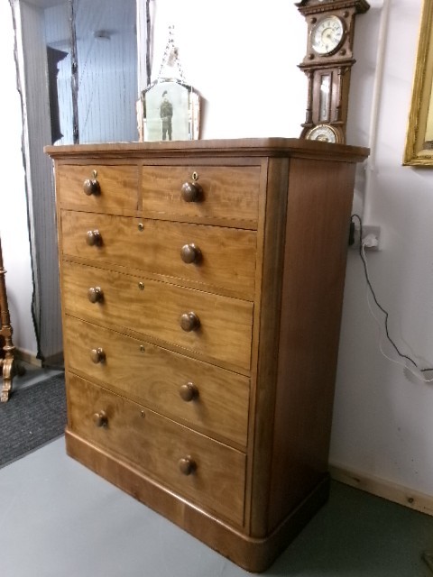 A tall Victorian mahogany chest of drawers featuring two short upper drawers above four long drawers with turned wooden knobs and a solid plinth base. View IX