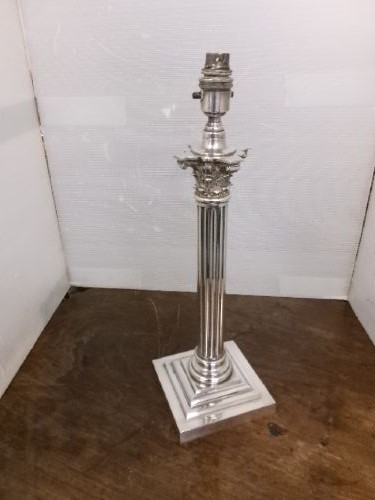A Victorian silver-plated table lamp shaped as a fluted Corinthian column resting on a stepped square base. View II