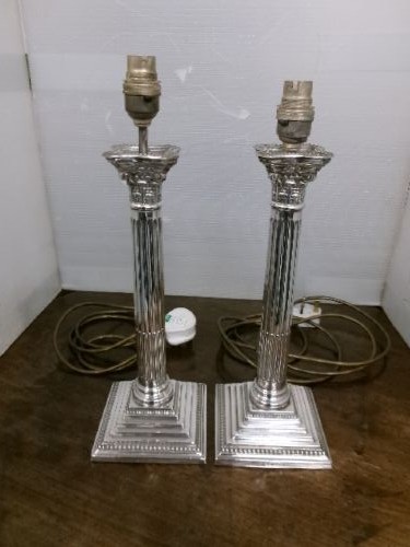 A pair of silver-plated table lamps designed as fluted Corinthian columns set upon square stepped bases. View IV