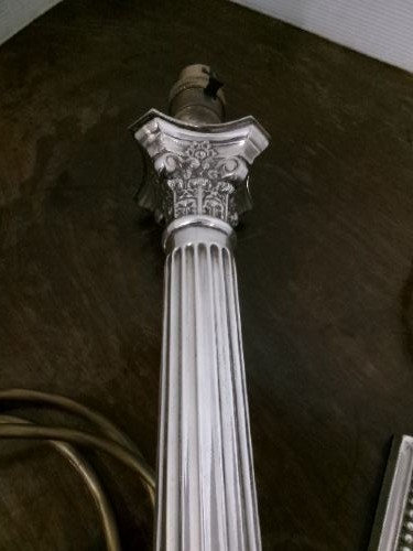 A pair of silver-plated table lamps designed as fluted Corinthian columns set upon square stepped bases. View VII