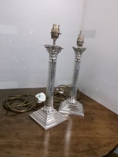 A pair of silver-plated table lamps designed as fluted Corinthian columns set upon square stepped bases. View XI