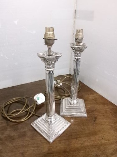 A pair of silver-plated table lamps designed as fluted Corinthian columns set upon square stepped bases. View X