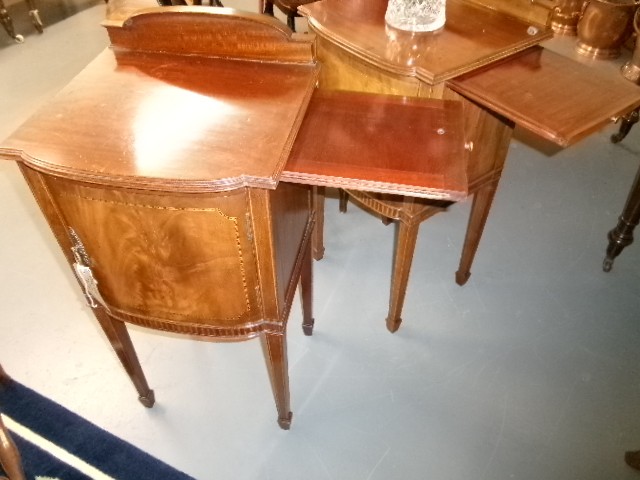 A pair of Edwardian mahogany bedside cabinets featuring bow fronts, satinwood string inlay, shaped upstands, and tapered legs. View XIII