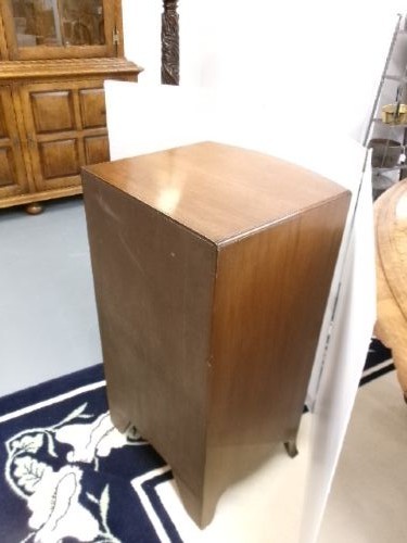 An Edwardian bow-front mahogany cabinet featuring two upper drawers with brass knobs over a panelled cupboard door. View V
