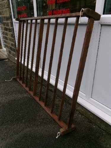 A rectangular 19th-century pine oatcake drying rack featuring slatted timber bars and hanging rope loops.