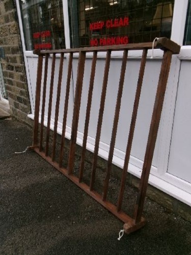 A rectangular 19th-century pine oatcake drying rack featuring slatted timber bars and hanging rope loops. View II