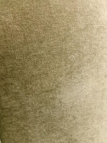 A high-backed Georgian style wing armchair upholstered in textured olive green fabric with dark wooden legs. View III