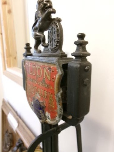 A Victorian cast iron and brass commercial weighing scale featuring a top lion crest, brass pan, and ceramic platform. View VII