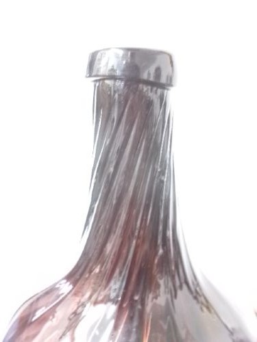 A deep amethyst hand-blown glass bottle featuring a bulbous onion-shaped body, a spiral-ribbed tapering neck, and an applied string lip rim. View III