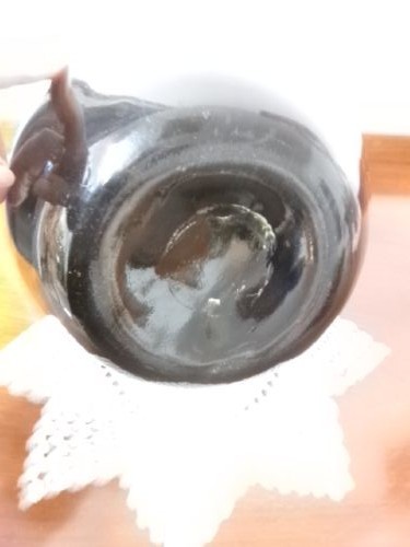 A dark green hand-blown glass onion bottle featuring a broad bulbous body, a long tapered neck, and an applied glass string rim. View IV