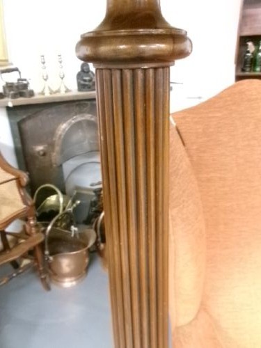 A dark turned mahogany standard lamp with a fluted central column and a moulded circular base. View II