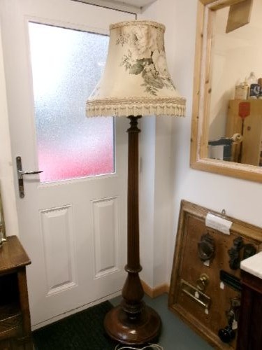 A dark turned mahogany standard lamp with a fluted central column and a moulded circular base. View III