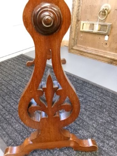 A freestanding Victorian mahogany towel rail featuring carved scrollwork supports and multiple horizontal rails on trestle feet. View III