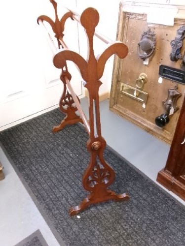A freestanding Victorian mahogany towel rail featuring carved scrollwork supports and multiple horizontal rails on trestle feet. View IV