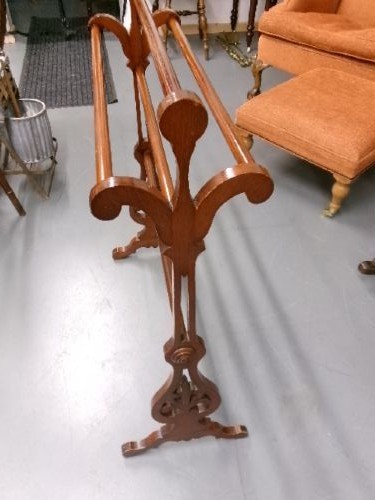 A freestanding Victorian mahogany towel rail featuring carved scrollwork supports and multiple horizontal rails on trestle feet. View IX
