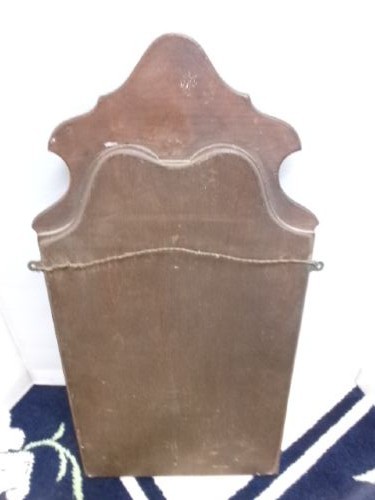 An antique walnut wall mirror with an arched, shaped top cresting and moulded frame. View V