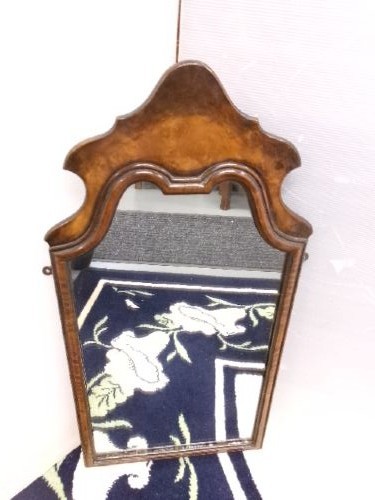 An antique walnut wall mirror with an arched, shaped top cresting and moulded frame. View VIII