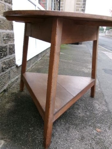 A 19th-century pine cricket table featuring a smooth round top supported by three splayed legs and a triangular undershelf. View II