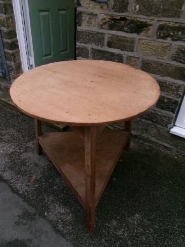 A 19th-century pine cricket table featuring a smooth round top supported by three splayed legs and a triangular undershelf. View VI